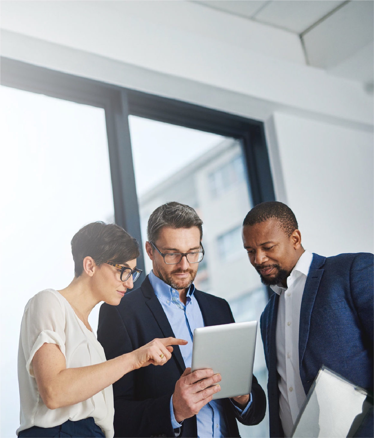 Businessman demonstrating a tablet app to his colleagues