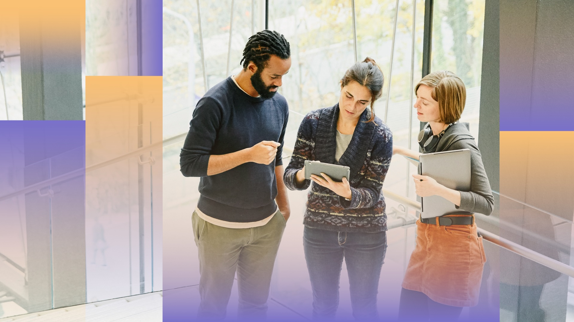 Co-workers discuss a work project on an office stairwell