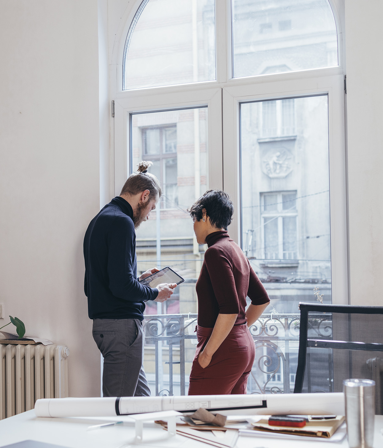 Coworkers standing by window